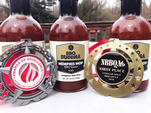 Award-winning BBQ Buddha Memphis Mop BBQ Sauce bottles with first place and excellence medals