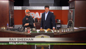Chef Ray Sheehan presenting BBQ sauces and burgers on a TV cooking show kitchen set.
