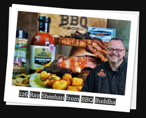 Chef Ray Sheehan smiling with BBQ ribs, fried food, and BBQ Buddha sauces, BBQ Box in background