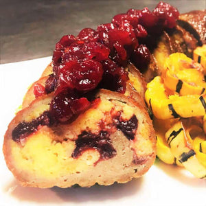 Smoked turkey fatty stuffed with cranberry and topped with cranberry sauce, served with roasted squash.