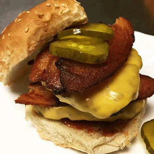 Gourmet cheeseburger with crispy bacon, pickles, and sesame bun from Chef Rays LLC.