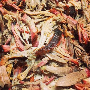 Close-up of juicy pulled pork barbecue, highlighting tender, smoky meat from Chef Rays LLC.