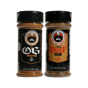 Two spice rub bottles on a plain white background: The OG BBQ Rub on the left and The Beef Rub on the right, both by Chef Ray Sheehan. The bottles are clear plastic with black caps and black labels, showing brown seasoning inside.
