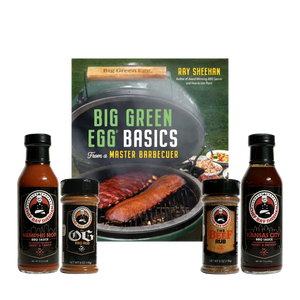 A barbecue-themed product bundle centered around the book 'Big Green Egg Basics From a Master Barbecuer' by Ray Sheehan, with four branded seasoning and sauce items arranged in front on a transparent background.