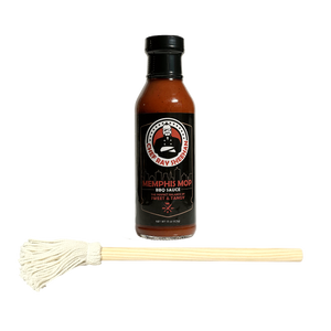 A bottle of Ray Sheehan's Memphis Mop BBQ Sauce arranged side by side, with a small white cotton mop handle placed horizontally in front on a transparent background.