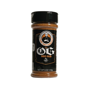 A 6 oz bottle of The OG BBQ Rub by Chef Ray Sheehan, featuring a black cap and a black label with orange and white branding, set against a transparent background.