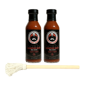 Two bottles of Ray Sheehan's Memphis Mop BBQ Sauce arranged side by side, with a small white cotton mop handle placed horizontally in front on a transparent background.
