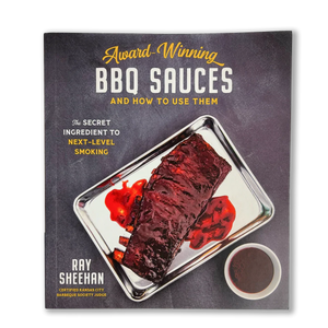 Award-Winning BBQ Sauces cookbook by Ray Sheehan featuring sauced ribs on a tray
